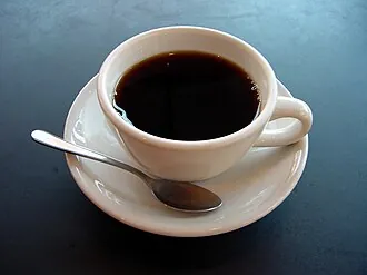 Cup of black coffee and roasted coffee beans